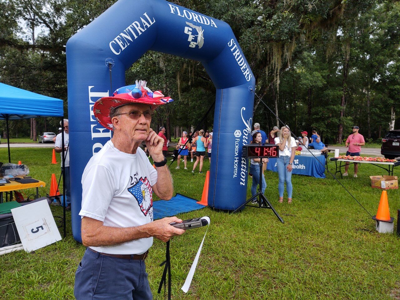 Firecracker Race Master Chet Brojeck gazes intently as the runners enter the picnic area for their finish in July 2021.